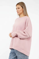 NAIRA Cozy Sweater in soft brushed cotton with relaxed A-line fit and rounded hem in light pink