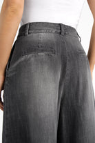 Back view of NEDITA Cropped Wide Leg Hose in washed black with faded gradient and mid waist design.