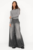 Woman wearing NEDY Wide Leg Hose in washed black with soft gradient and wide silhouette.