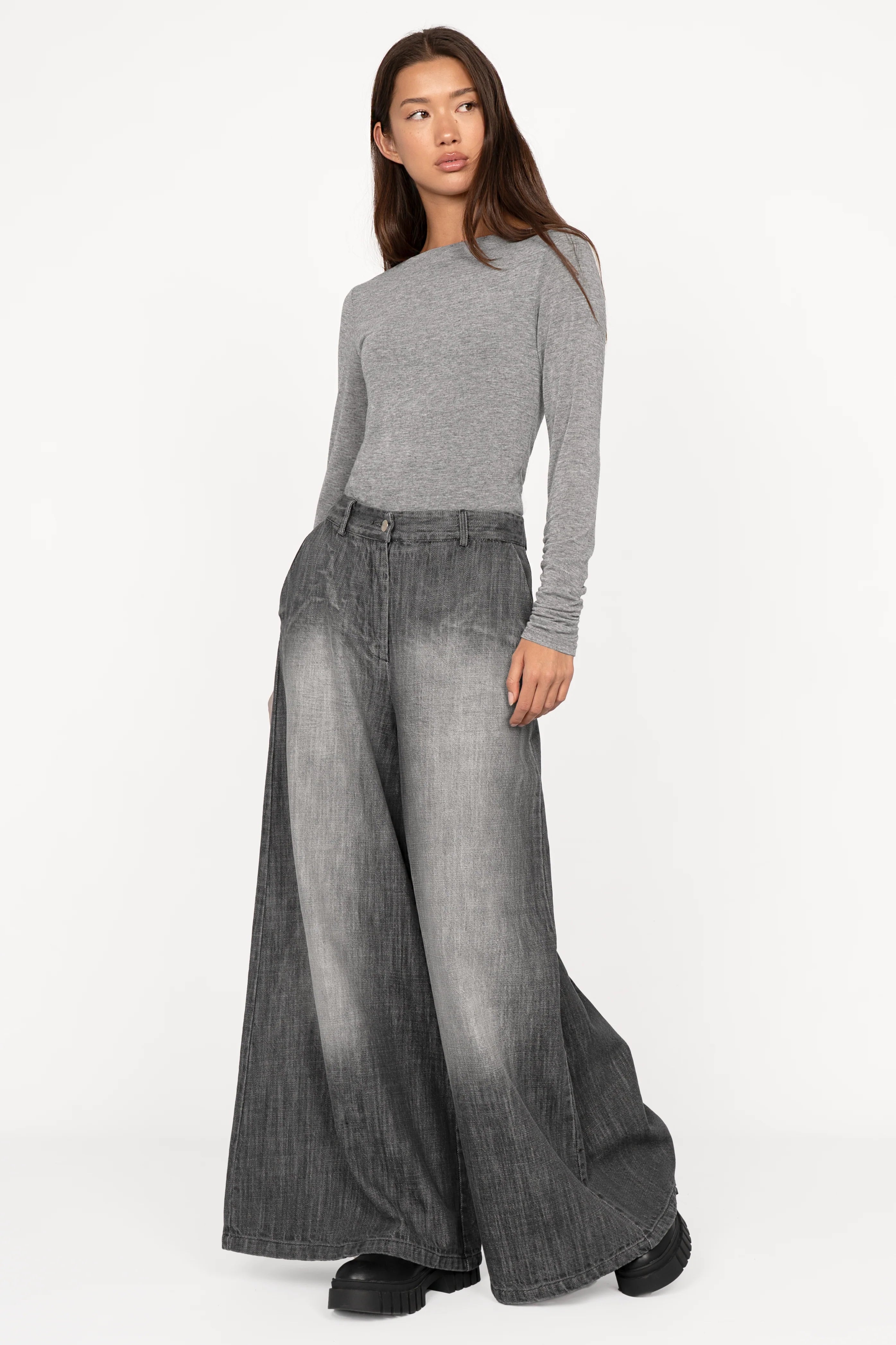Woman wearing NEDY Wide Leg Hose in washed black with soft gradient and extra-wide silhouette.