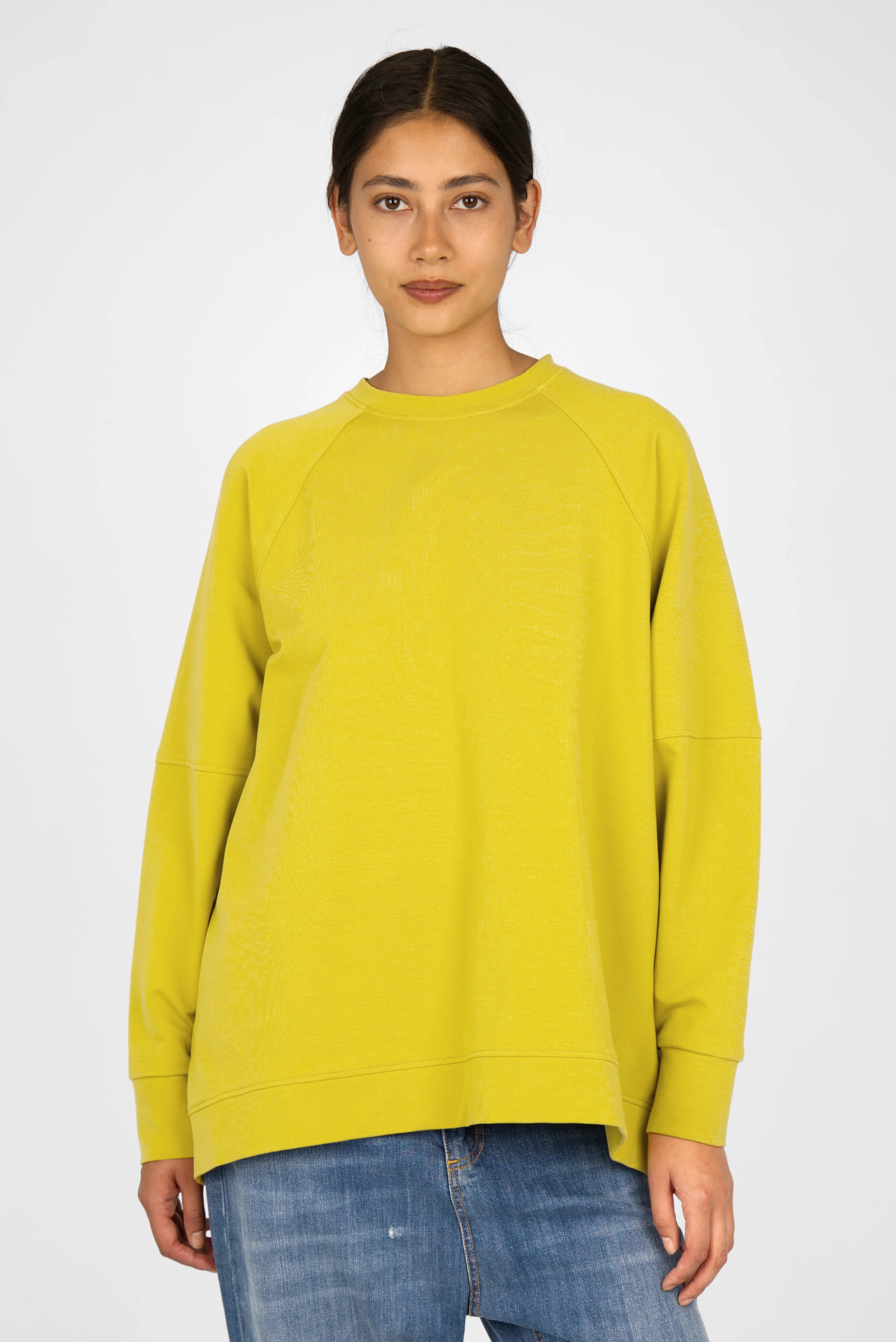Woman wearing yellow SELKA Sweater with raglan sleeves and A-line relaxed fit