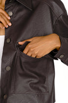 Close-up of a cropped SOOAE shirt jacket in supersoft eco-leather with large front pocket and snap buttons