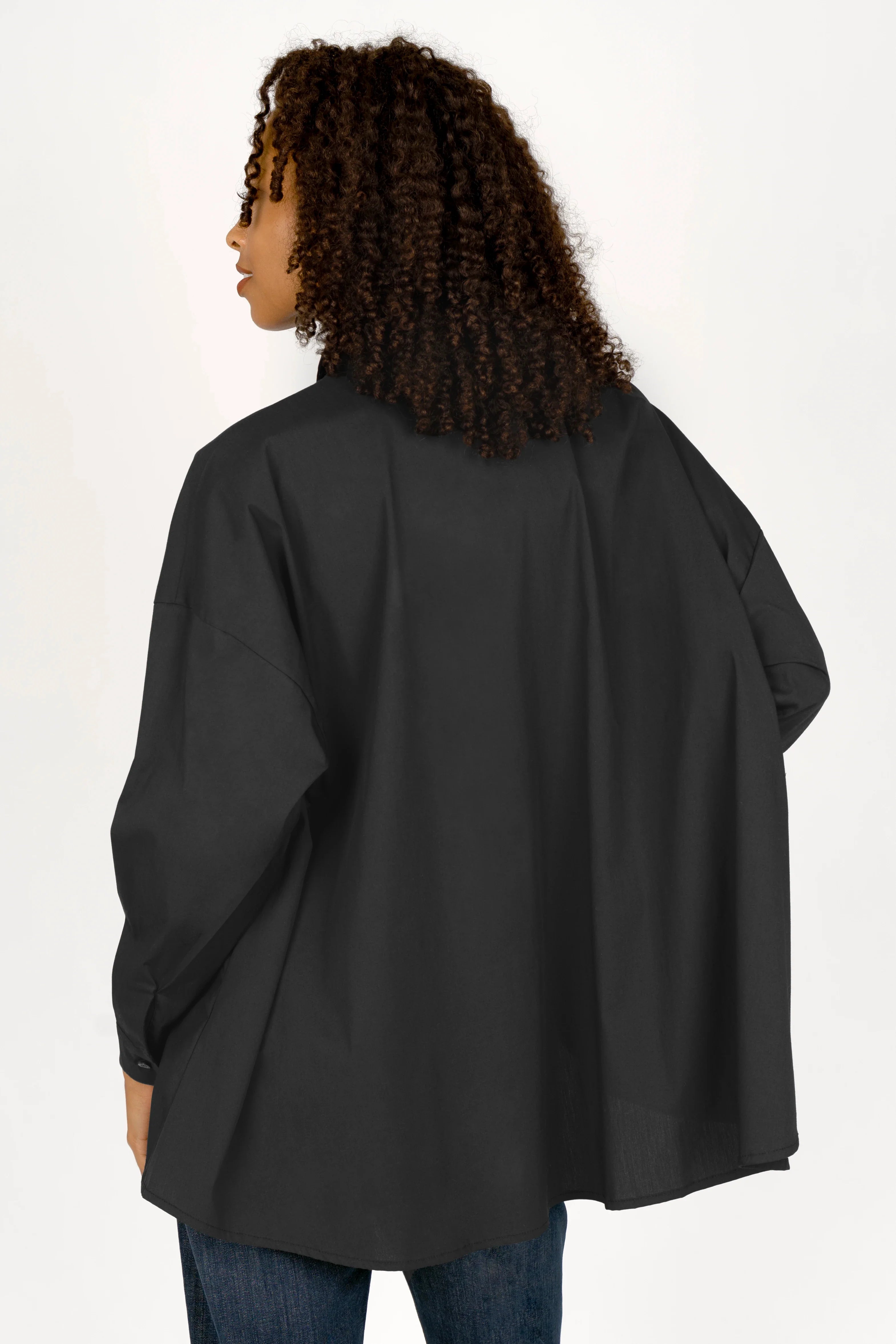 Black oversized blouse in A-line shape with dropped shoulders and long sleeves
