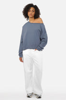 One Shoulder Sweater in soft sweat fabric with wide neckline, extended cuffed sleeves, and loose fit.