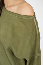 TIMAJ Revive One Shoulder Sweater in olive green with wide neckline and relaxed fit showcasing exposed shoulder and cuffed sleeves