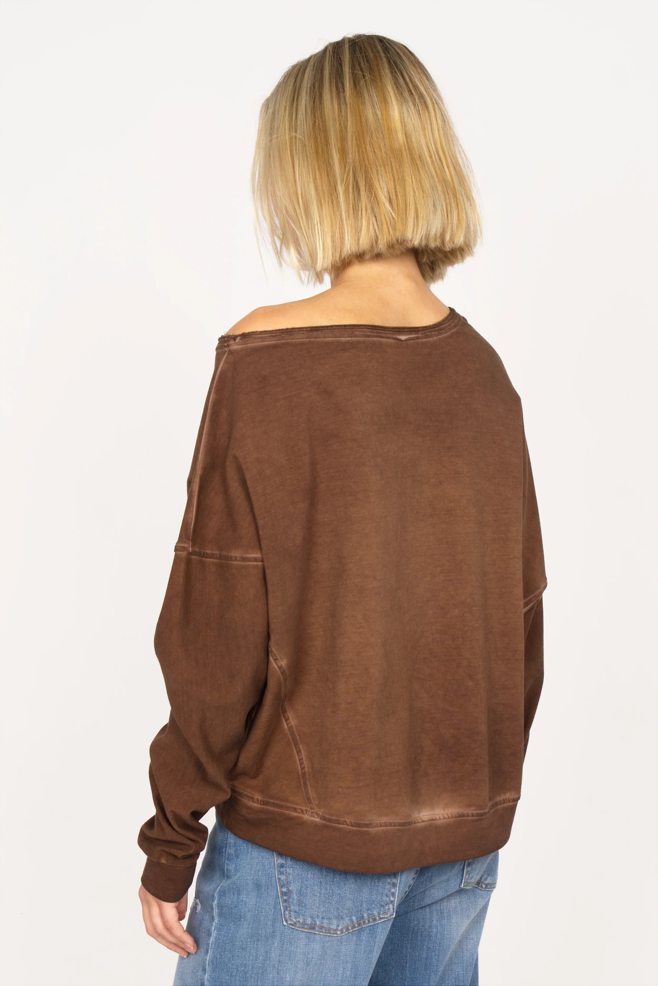 TIMAJ Revive One Shoulder Sweater in mocha vintage wash with loose fit and raw edge wide neckline, worn off one shoulder.