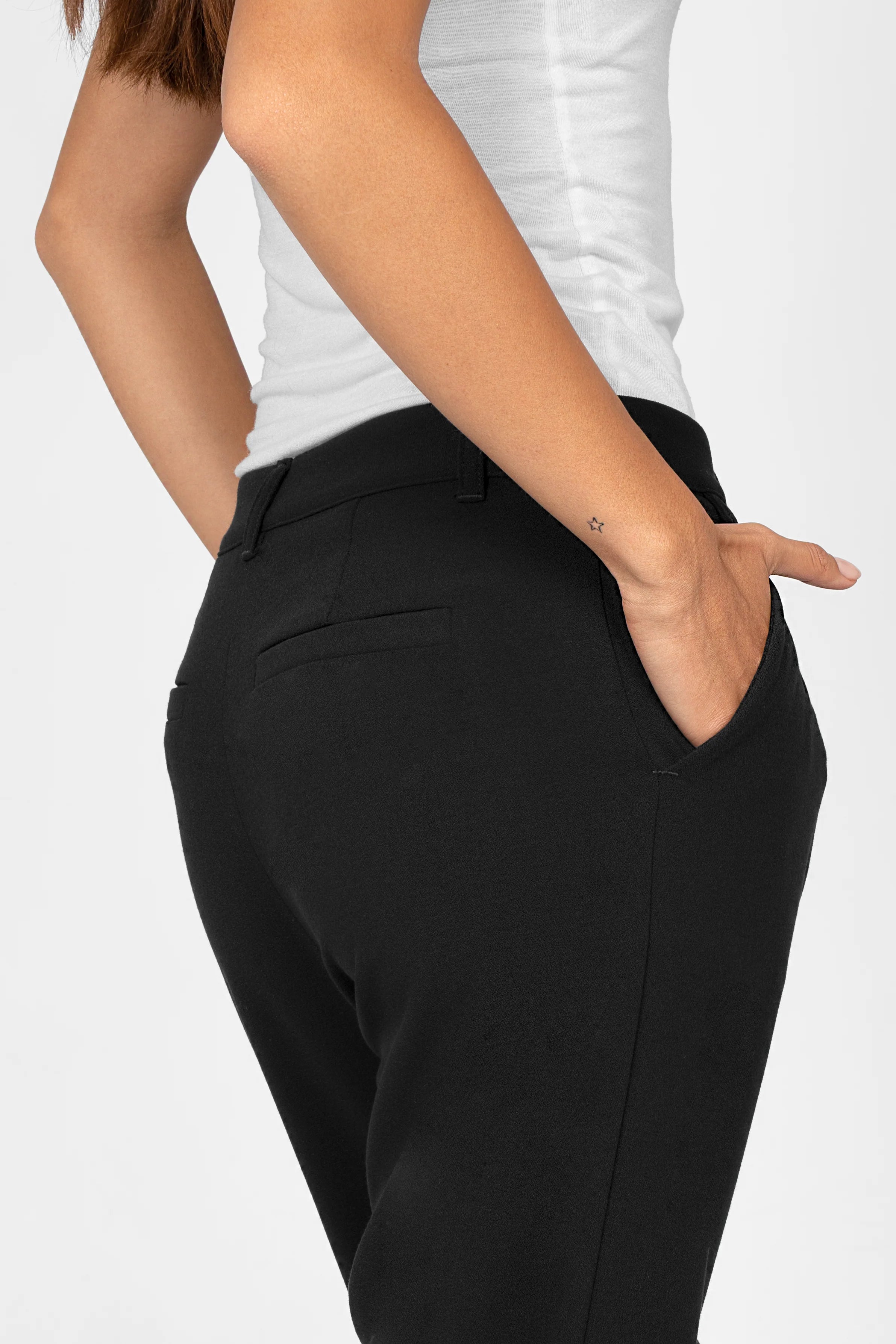 Black TINKE Hose Cropped fit pants with side pocket and relaxed hip fit, worn with white top