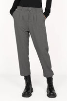 Gray TINKE Hose Cropped fit pants with pleats, zipper, and button closure worn with black boots