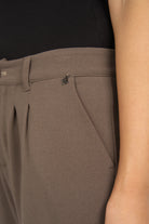 Close-up of taupe TINKE Hose Cropped with pleats and zipper detail on hip